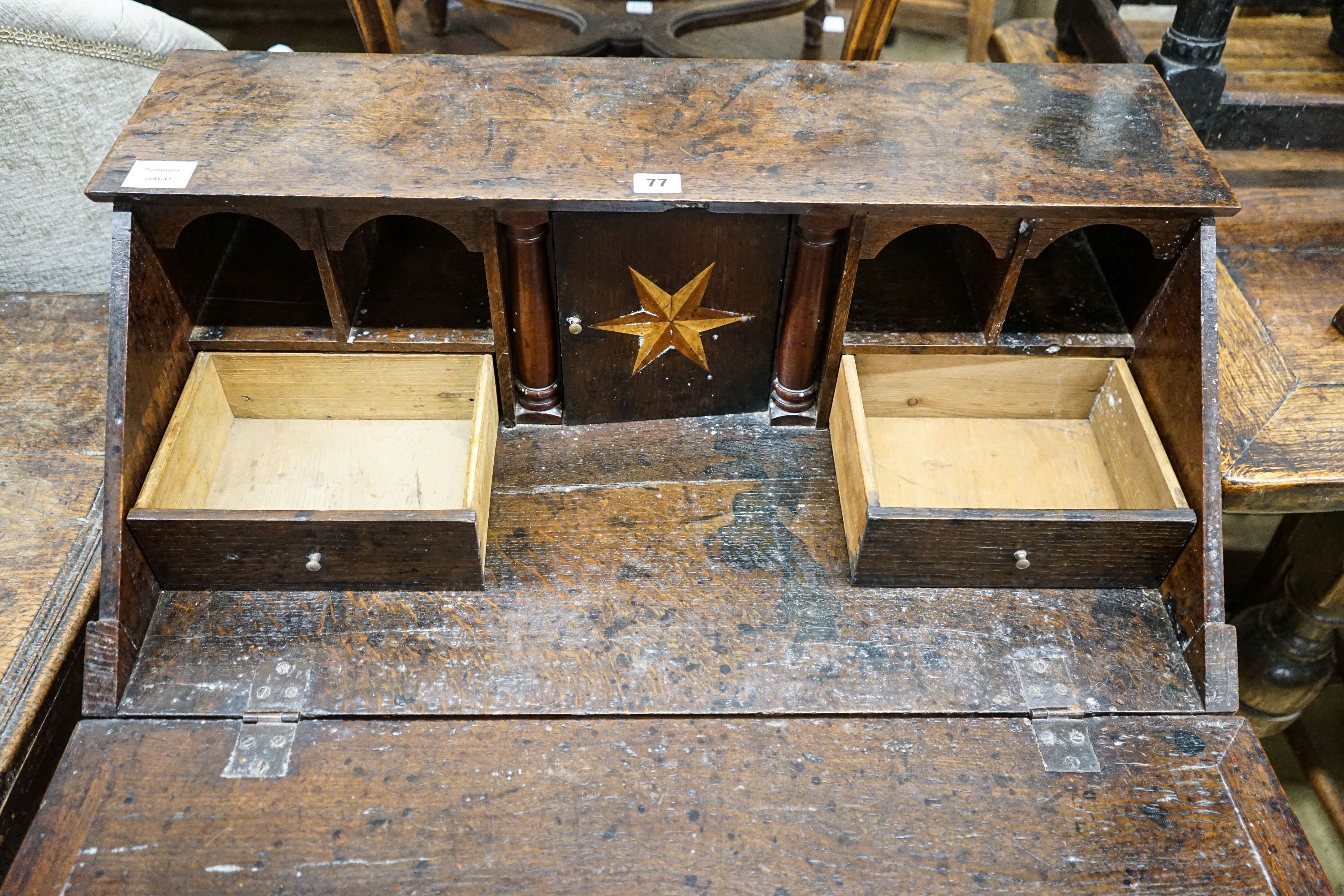 A mid 18th century inlaid oak and elm bureau, with fitted interior and single drawer, width 77cm, depth 45cm, height 94cm